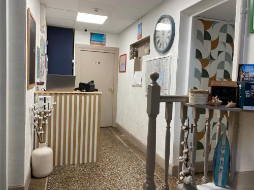a room with a hallway with a clock on the wall at Logis Hôtel Villa Victorine in Nice