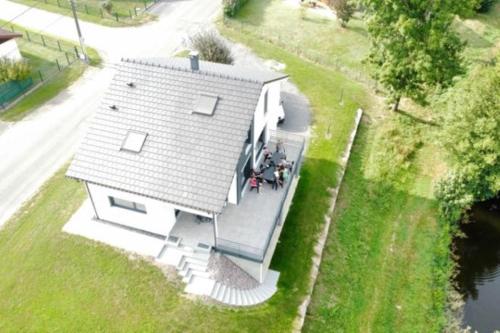 an overhead view of a white house with a porch at Maison spacieuse au bord d'un étang et face à la nature in Ban-sur-Meurthe-Clefcy