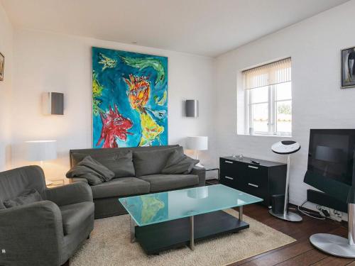 a living room with a couch and a painting on the wall at 2 person holiday home in Skagen-By Traum in Skagen