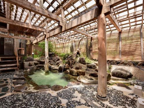 a room with a pool of water in a building at Yumorinoyado Sannozyou in Mogami