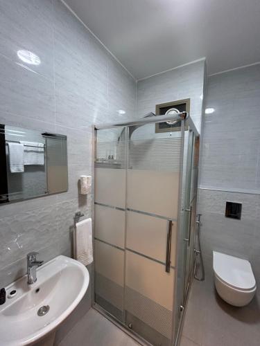 a bathroom with a shower and a sink and a toilet at Petra Brothers in Petra