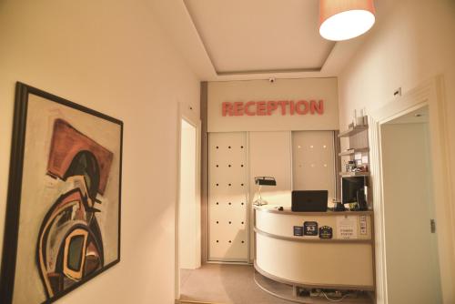 a room with a room with arosis sign on the wall at Apartments Legacy in Belgrade