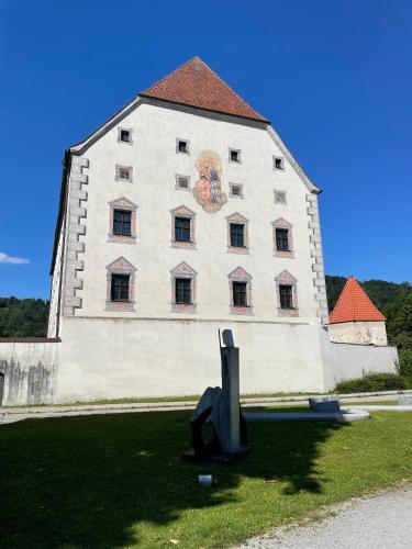 a large white building with a mural on the side of it at Ferienwohnung Hofmann mit Balkon und Donaublick in Obernzell