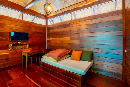 a small room with a bench in a wooden wall at The For Rest Resort in Sai Yok