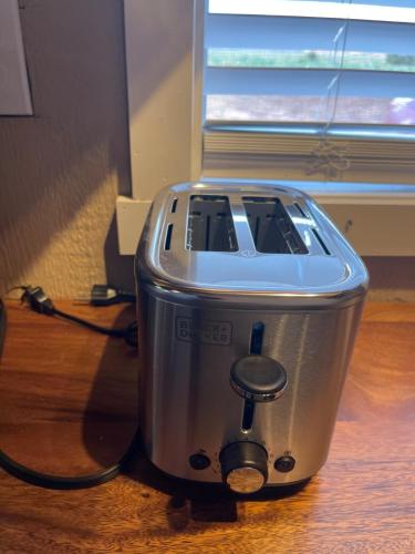a toaster sitting on top of a wooden table at Tiny Tiny Bunkhouse in Cane Beds