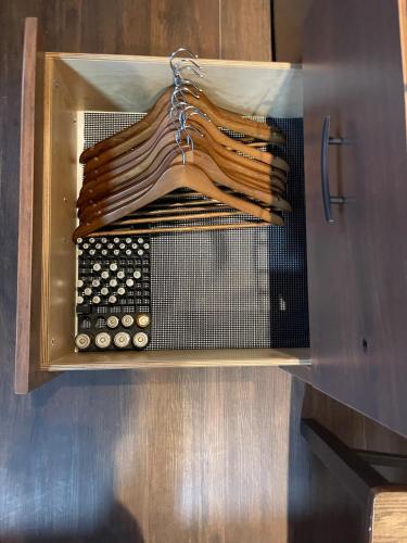 a microwave oven with a bunch of utensils at Tiny Tiny Bunkhouse in Cane Beds