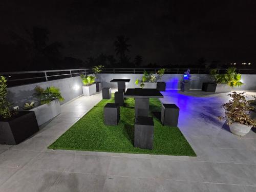 a patio with a table and some plants at night at Green Vibe Apartments in Nugegoda