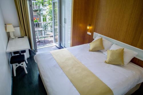 Ένα ή περισσότερα κρεβάτια σε δωμάτιο στο Hotel Larende