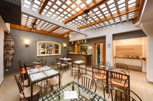a restaurant with tables and chairs in a room at Hostal San Lorenzo in Madrid