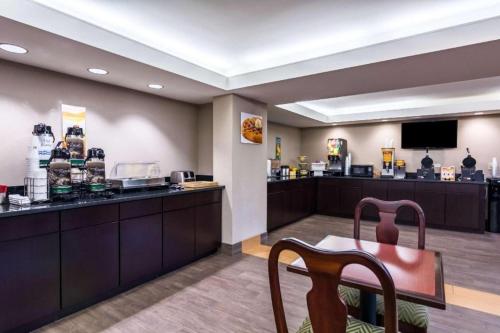 a waiting room with a table and a chair at Quality Inn in Manassas