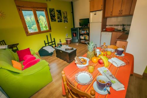 a living room with a table with food on it at Casa Rural Aguas Frias II in La Omañuela