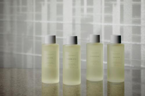 a group of three shampoo bottles sitting on a table at Four Seasons Hotel Osaka in Osaka