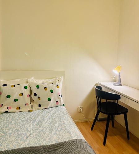a bedroom with a bed with a chair and a desk at Quiet Private Rooms Easy Metro & Airport Access in Vantaa