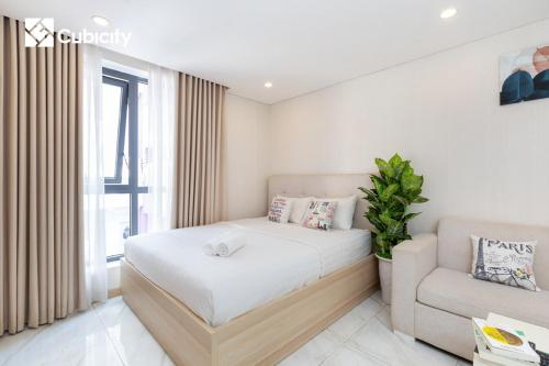 a small bedroom with a bed and a couch at Cubicity Hidden House in Ho Chi Minh City