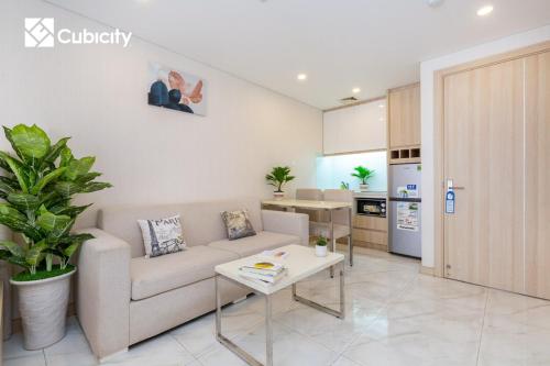 a living room with a couch and a table at Cubicity Hidden House in Ho Chi Minh City