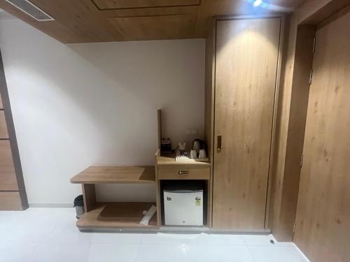 a small room with a desk and a door at Nirvana Grand Hotel & Resort in Gaya