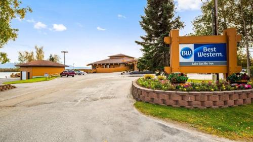 a sign for a best western sign in front of a building at Best Western Lake Lucille Inn in Wasilla