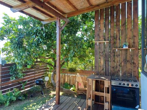 an outdoor kitchen with a stove in a backyard at Le Tahiti Bungalow Surf Lodge in Haapape