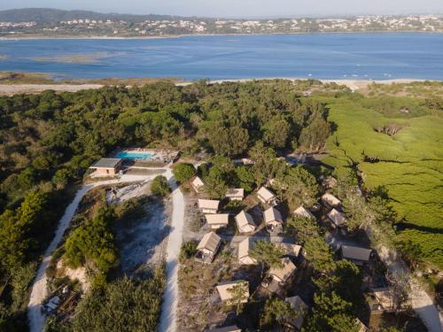 an aerial view of a house with the water at Huttopia Lagoa de Óbidos in Casal do Narcizo