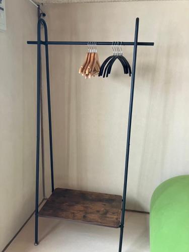 a metal stand with hangers on a wall at 御太刀屋 in Oishi