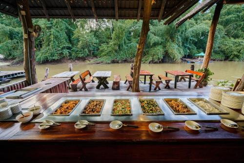 a buffet of different types of food on a table at The For Rest Resort in Sai Yok