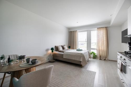 a living room with a bed and a table at Lapin Kansa Suite in Rovaniemi
