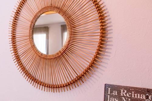 a mirror hanging on a wall next to a sign at El Rincón de Eva l Terraza l Wifi l Luminoso in Sabiñánigo