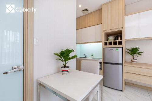 a kitchen with a white counter and a refrigerator at Cubicity Hidden House in Ho Chi Minh City