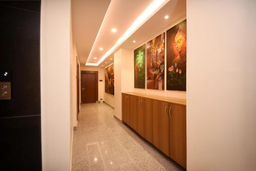 a hallway with paintings on the walls in a building at Hotel Cozy Heaven in Kathmandu