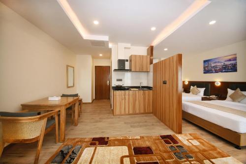 a hotel room with a bed and a desk and a kitchen at Hotel Cozy Heaven in Kathmandu