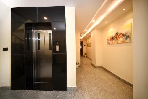a hallway with a glass elevator in a building at Hotel Cozy Heaven in Kathmandu