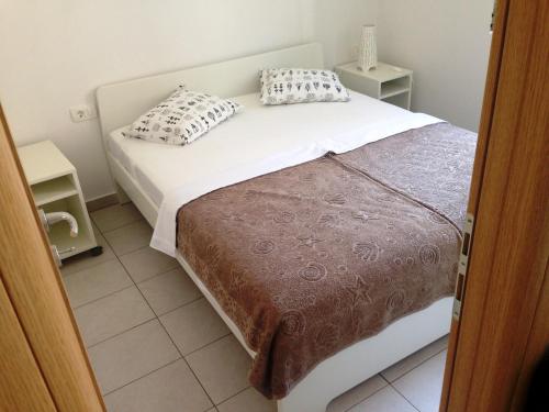a bedroom with a bed with two pillows on it at Villa Neka in Primošten