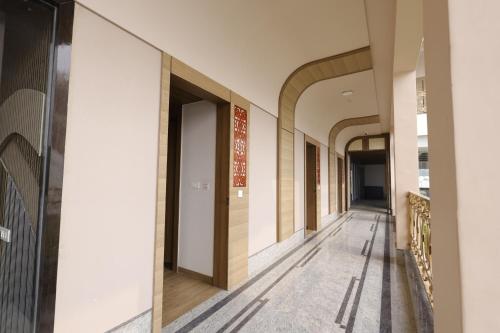 a hallway of a building with arches at Nirvana Grand Hotel & Resort in Gaya