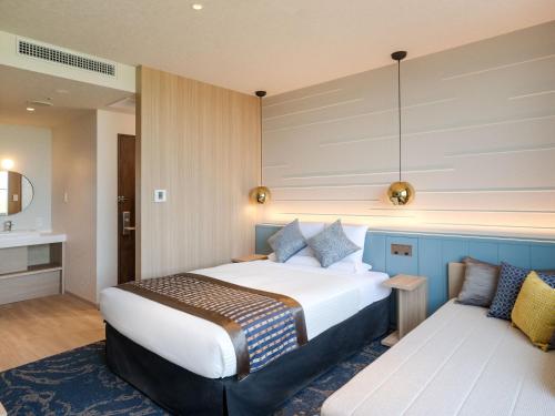 a hotel room with a bed and a couch at KAMENOI HOTEL Awajishima in Awaji