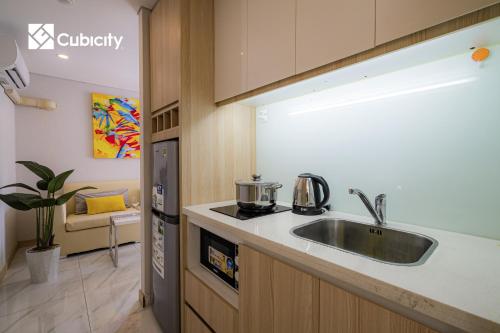 a kitchen with a sink and a counter top at Cubicity Hidden House in Ho Chi Minh City