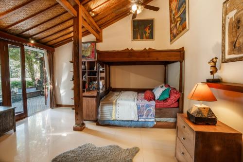 a bedroom with a bunk bed in a room at Villa Joglo Ayu in Uluwatu