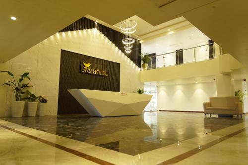 a lobby with a large white bench in the middle at A79 Hotel in Chennai