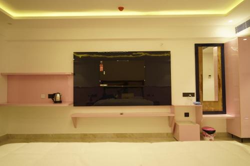 a bedroom with a bed and a large window at A79 Hotel in Chennai