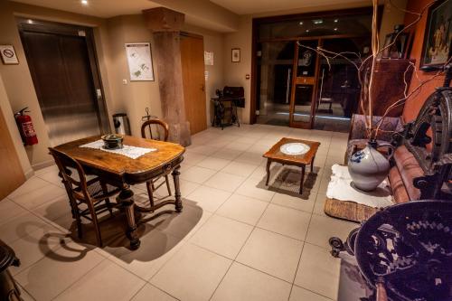 a living room with a table and a couch at L Ecrevisse in Wissembourg