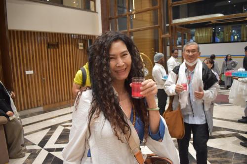 a woman holding a drink in a glass at Nirvana Grand Hotel & Resort in Gaya