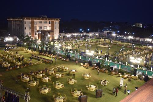 a crowd of people in a park at night at Nirvana Grand Hotel & Resort in Gaya