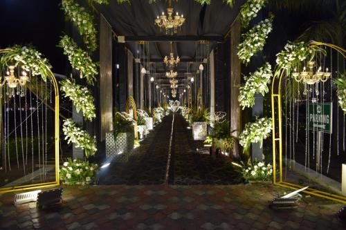 a hallway of a building with chandeliers at Nirvana Grand Hotel & Resort in Gaya