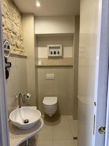 a bathroom with a white toilet and a sink at B&B Porta Verde in Castelbottaccio