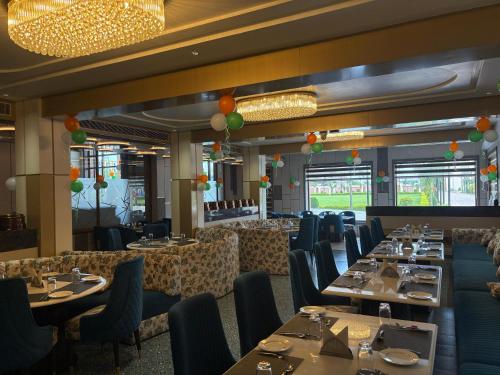 a dining room with tables and chairs with balloons at Nirvana Grand Hotel & Resort in Gaya