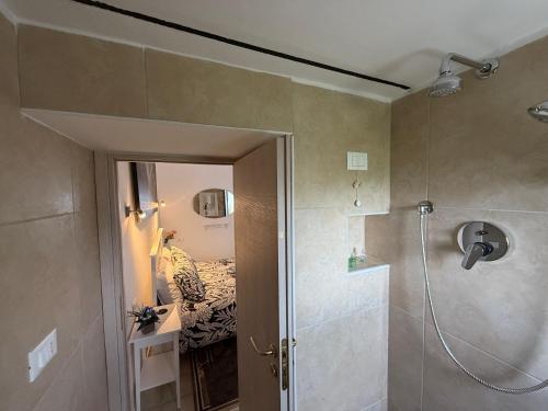 a bathroom with a shower and a bedroom with a bed at B&B Porta Verde in Castelbottaccio