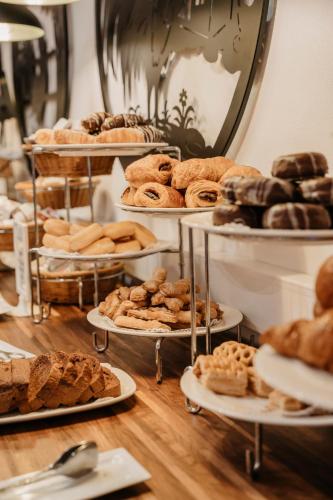 a bunch of different types of breads and pastries on shelves at Hotel Cerro La Nina in Beceña