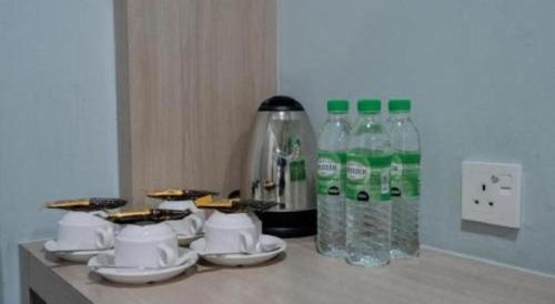a counter with a bunch of bottles of water at Kimal Hotel Taiping in Taiping