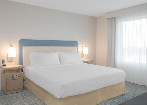 a bedroom with a large white bed and two lamps at Homewood Suites By Hilton Viera Melbourne in Melbourne