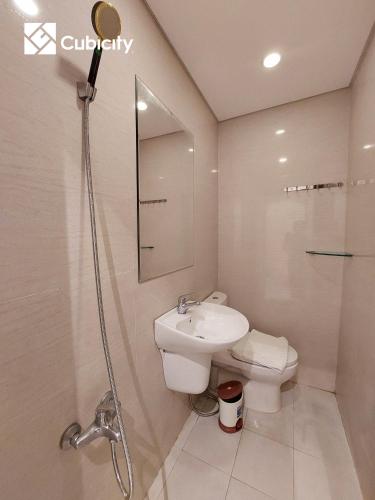 a bathroom with a sink and a toilet and a shower at Cubicity Hidden House in Ho Chi Minh City