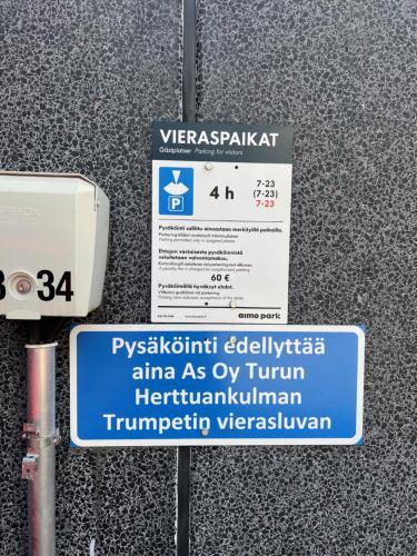 a sign on the side of a building with a sign at Kiva yksiö kahdelle in Turku